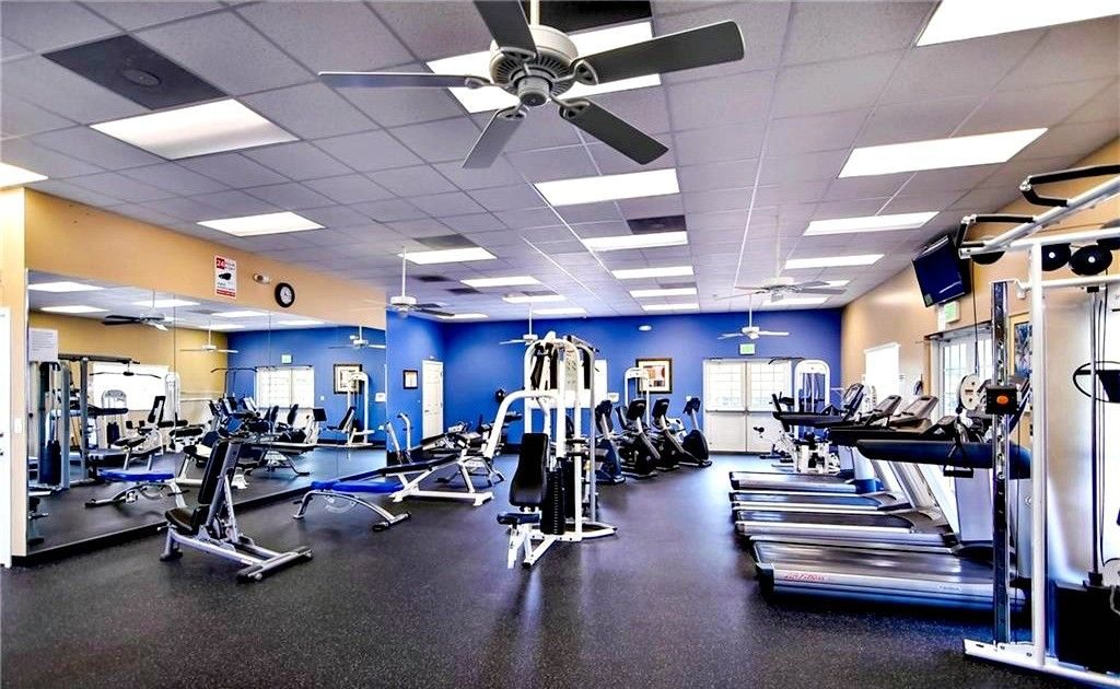 The fitness center with cardio machines and weights