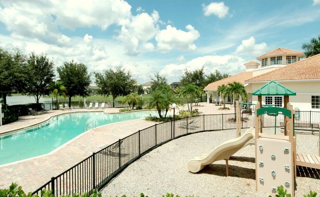 The pool deck and playground beside the lake