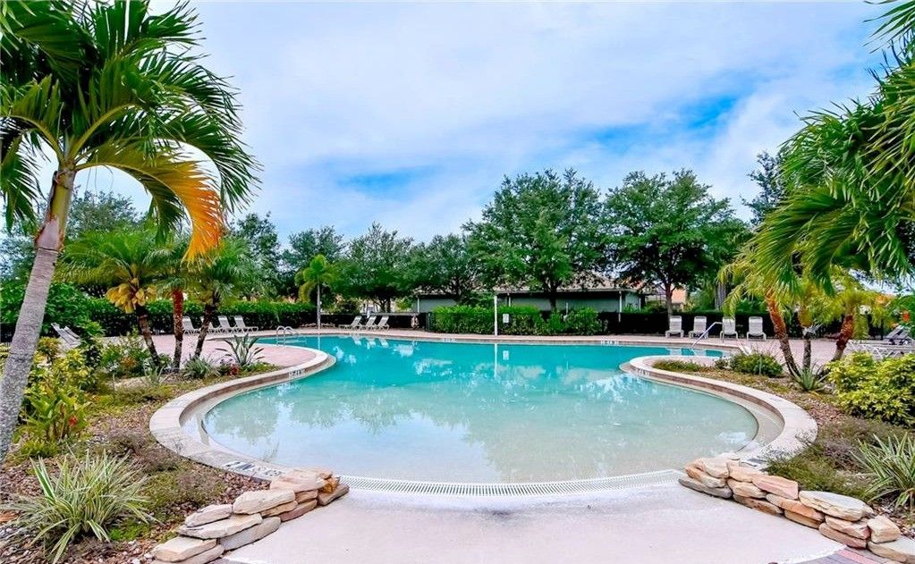 The Valencia Lakes pool, framed by palm trees